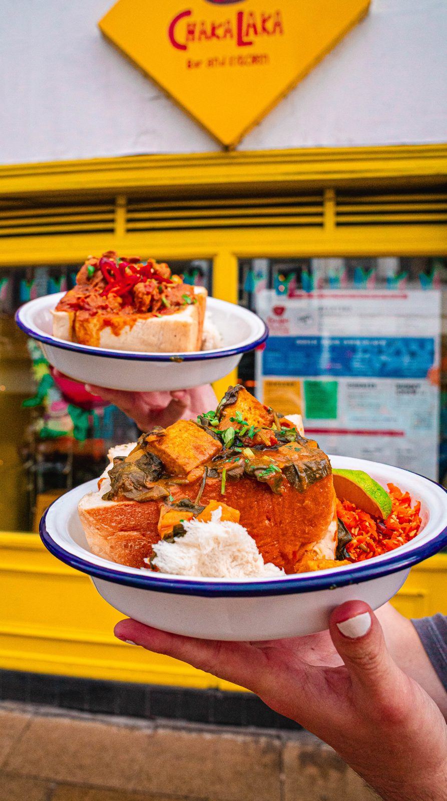 Bunny chow held up outside Chakalaka's yellow frontage
