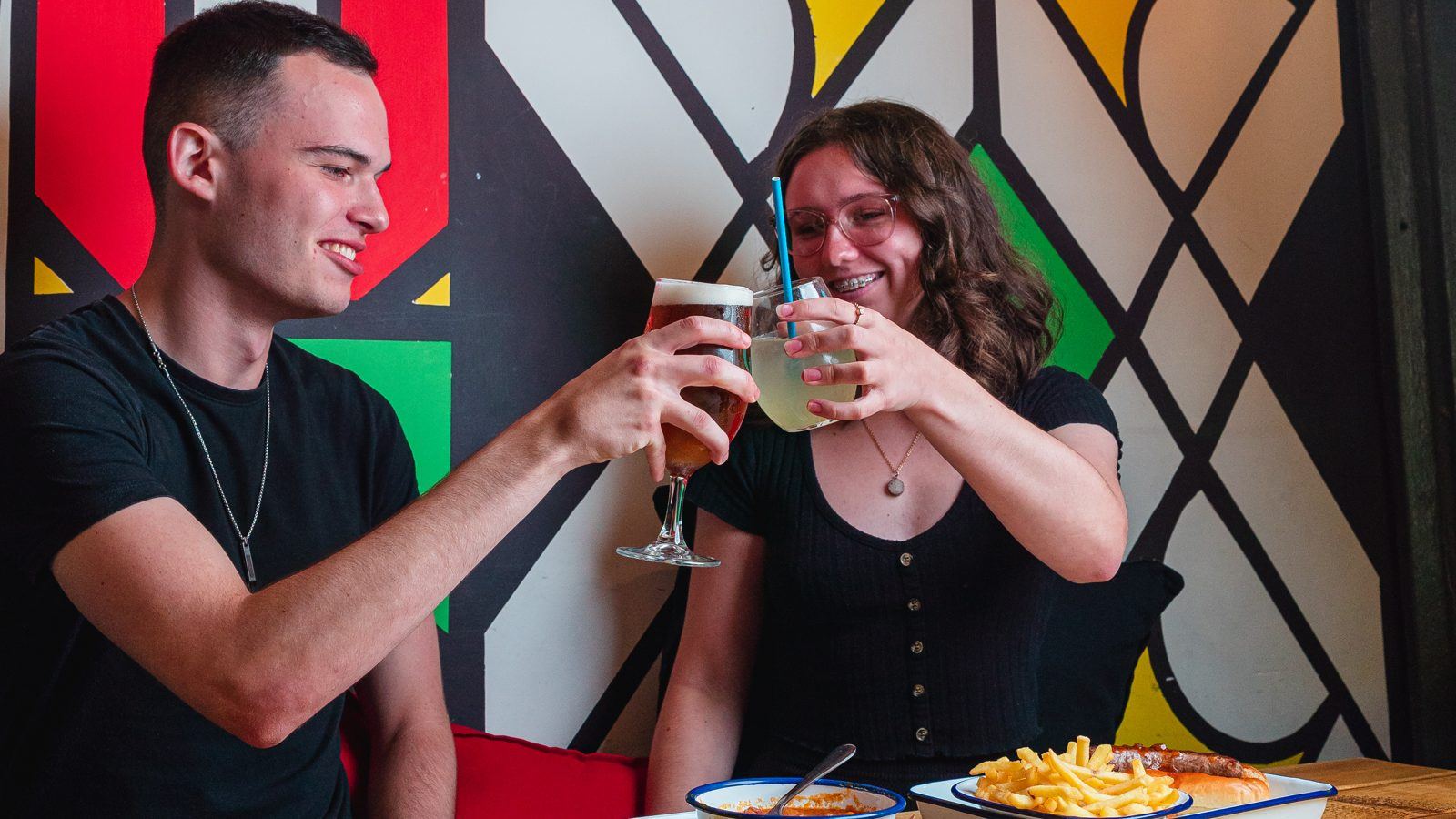 Guests toasting against Chakalaka's colourful painted wall