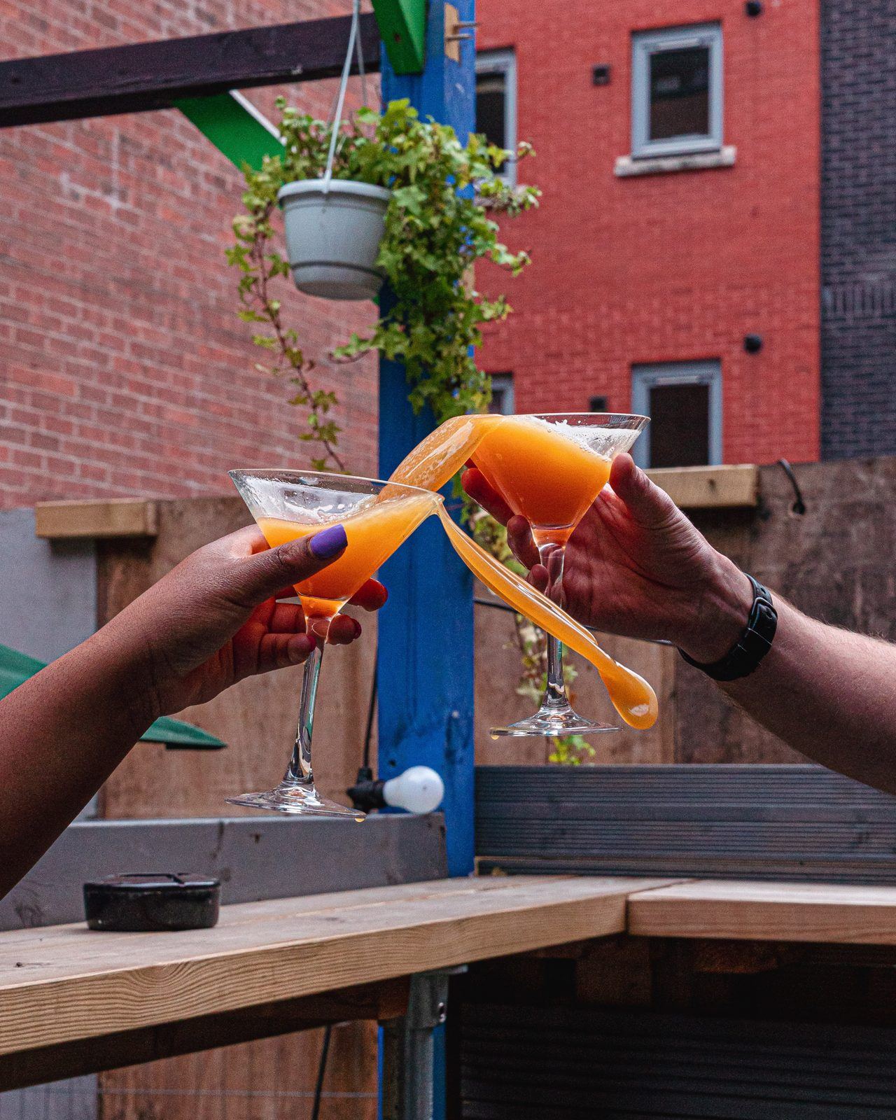 Friends raising cocktails on the terrace